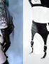 tattooed goth girl dressed in black shiny lingerie