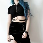 pastel goth girl wearing leather body harness with chain