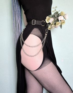 girl in stockings and garter harness holding flowers