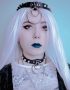 goth girl wearing choker with white pearls and rings