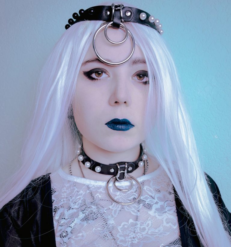 goth girl wearing choker with white pearls and rings