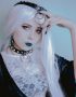 pastel goth lady wearing leather and pearl choker