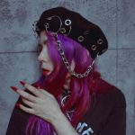 pastel goth girl in black woolen beret with chain