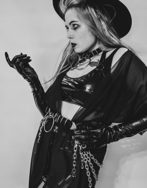 gothic girl in sexy black clothes wearing pvc belt